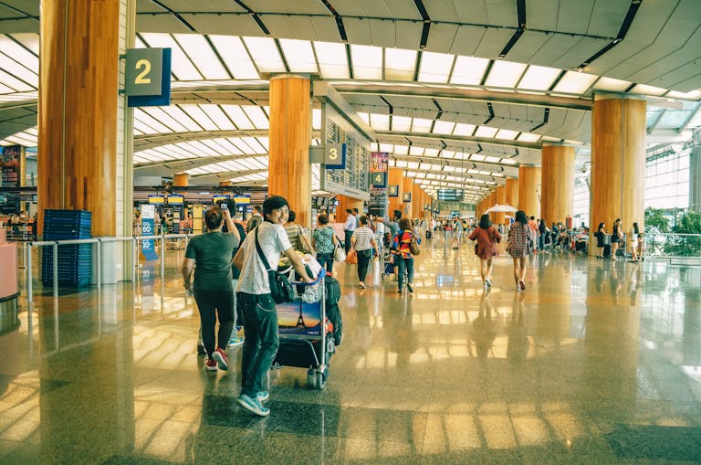 Meilen sammeln und clever reisen – junger Mann am Flughafen vor dem Check-in